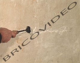Utilisez un grattoir pour élargir et approfondir la fissure du mur pour supprimer les parties non adhérentes, afin dassurer une meilleure prise  votre enduit. Vous pouvez également utiliser une brosse métallique pour éliminer toutes les particules de plâtre du mur qui ne tiennent pas.